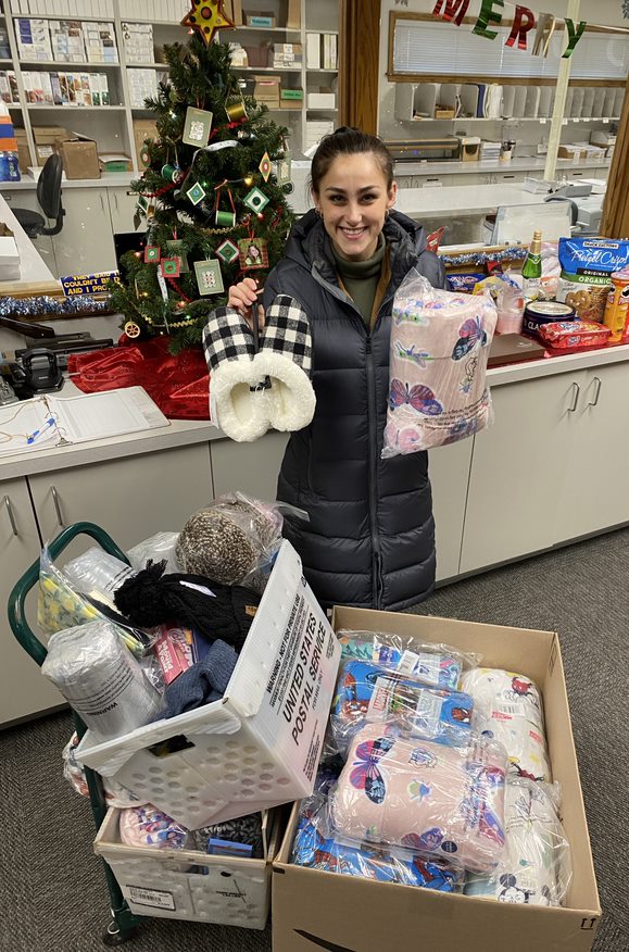 girl holding Christmas gifts