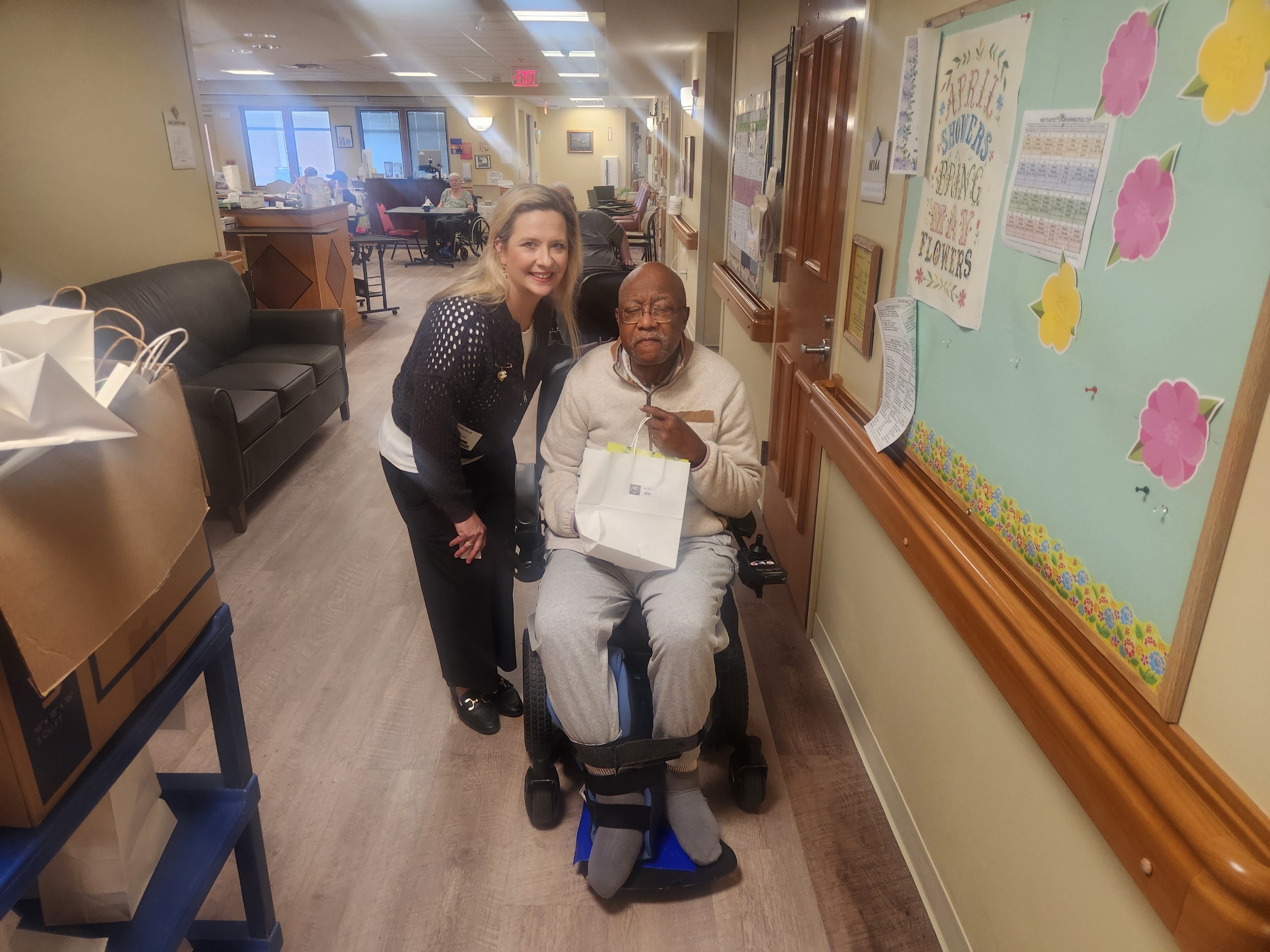 At Ease USA gives a May Day Bag to a man in a wheelchair