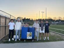 Soccer team stands by bins of pasta for Heartland Hope Mission